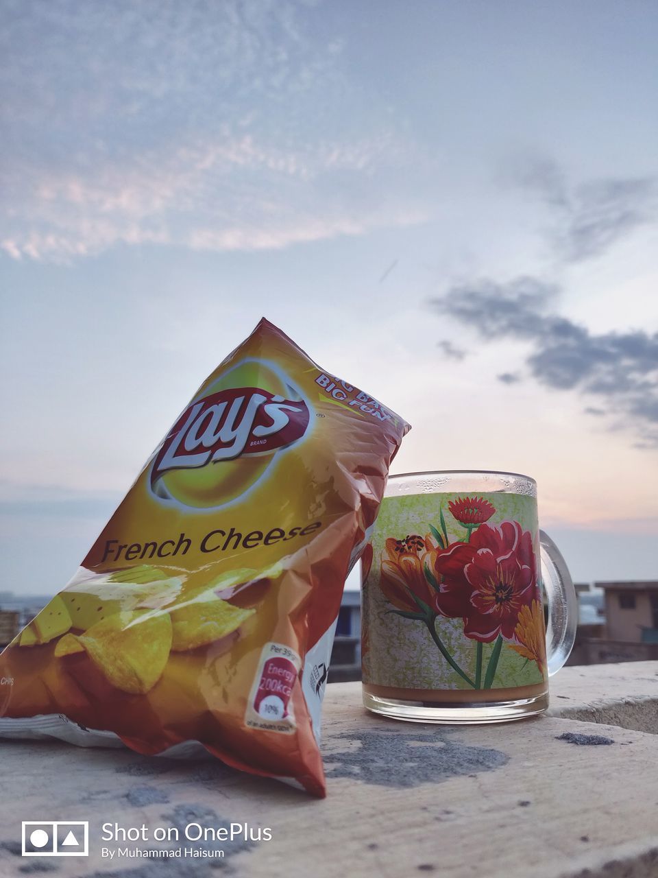 refreshment, food and drink, sky, drink, real people, day, healthy eating, food, table, nature, freshness, close-up, focus on foreground, fruit, text, beach, outdoors, lifestyles, holding, one person, glass