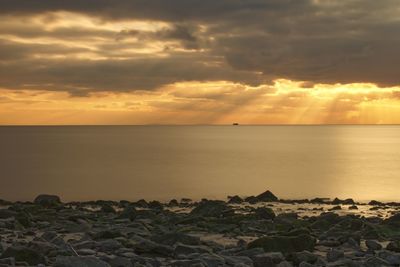 Scenic view of sea against cloudy sky