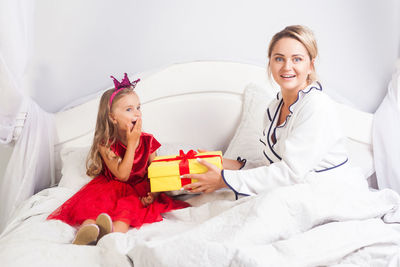 Mother giving gift to daughter