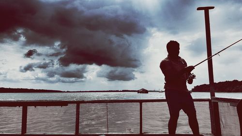 Full length of man playing soccer against sky