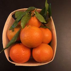 High angle view of orange fruits in bowl on table