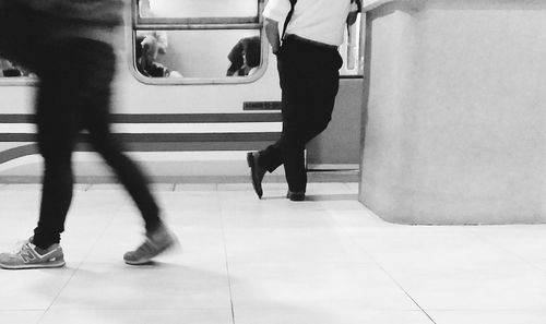 Low section of woman standing on subway station