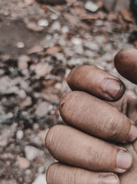 Close-up of hand holding cigarette