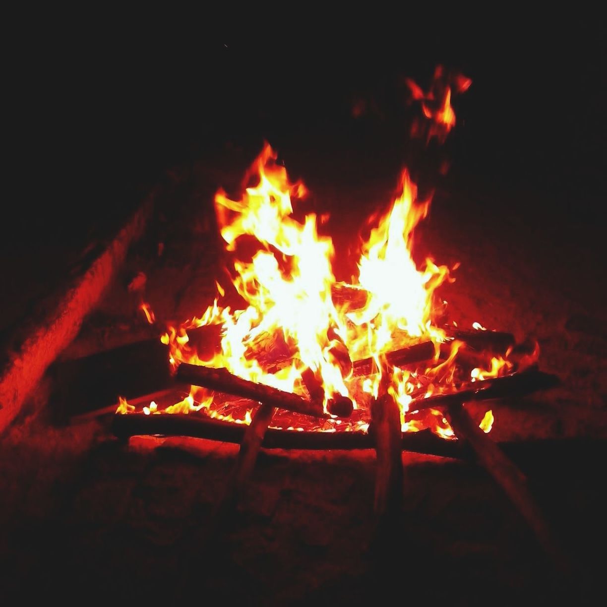 flame, burning, fire - natural phenomenon, heat - temperature, night, glowing, firewood, bonfire, fire, illuminated, heat, campfire, dark, close-up, orange color, lit, motion, indoors, candle, light - natural phenomenon