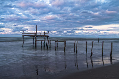 Lifeguard hut on beach against sky