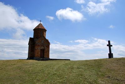 Castle on field against sky