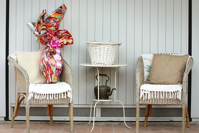 Wrapped gift on wicker chair in room