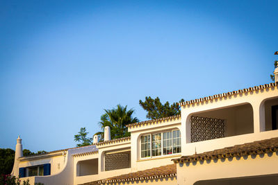 Low angle view of building against clear blue sky