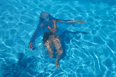 High angle view of woman swimming in pool