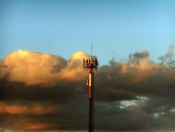 Low angle view of tower against sky at sunset