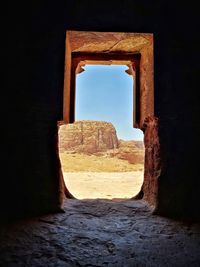 Open window of old ruin building against clear sky