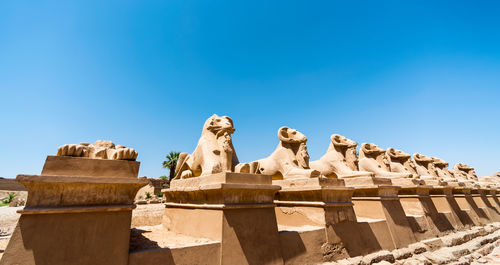 Low angle view of statue against blue sky