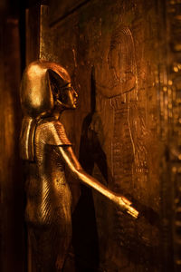 Rear view of woman standing by window