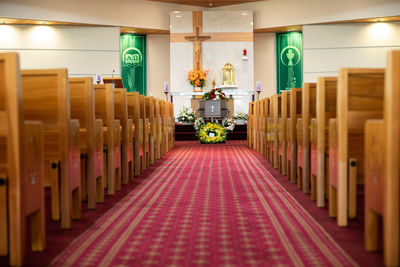 Closeup shot of a funeral casket or coffin in a hearse or chapel or burial at cemetery
