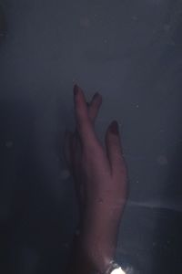 Close-up of woman hand in water