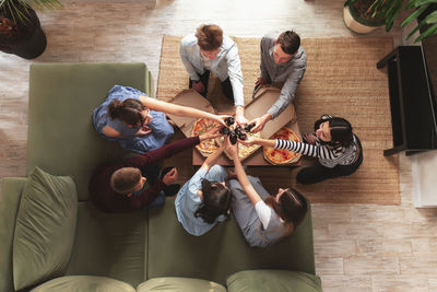 High angle view of people sitting on sofa