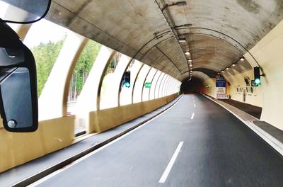 Empty road along built structures