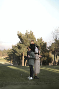Rear view of woman standing on field