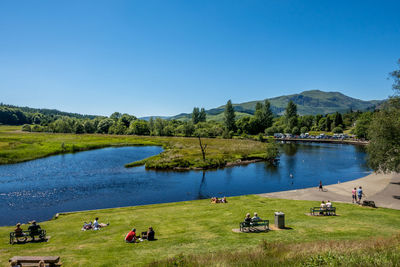 Scenic view of lake against clear blue sky