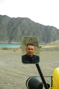 Low section of man standing on road