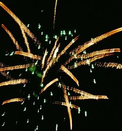 Low angle view of firework display at night