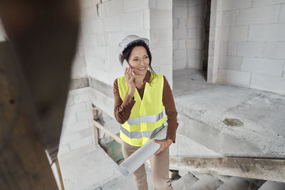 Engineer talking on phone at construction site