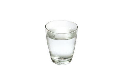 Close-up of glass of water against white background