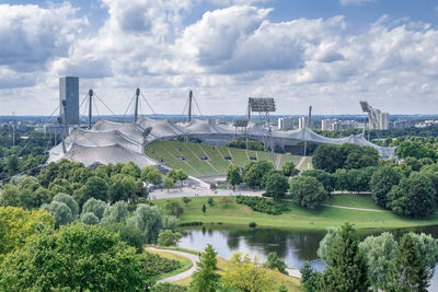 Bridge over river by city against sky