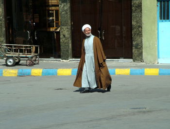 Portrait of man walking on road