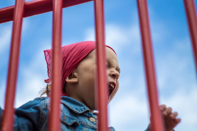 Portrait of girl looking away against sky