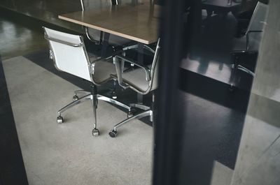 High angle view of empty chairs and table in building