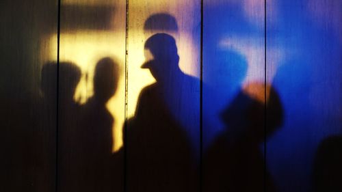 Shadow of woman standing on tiled floor