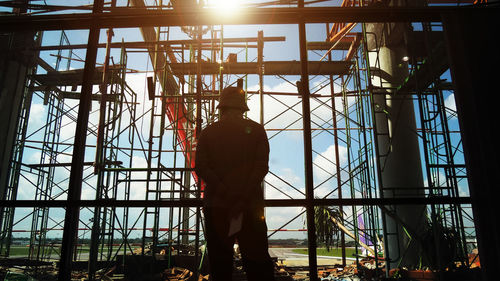 Worker man standing at the construction site