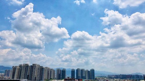 Modern buildings in city against sky
