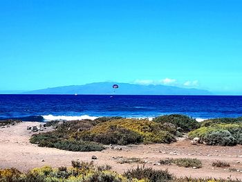 Scenic view of sea against blue sky