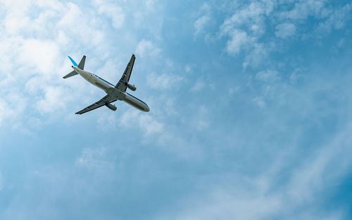 Low angle view of airplane flying in sky