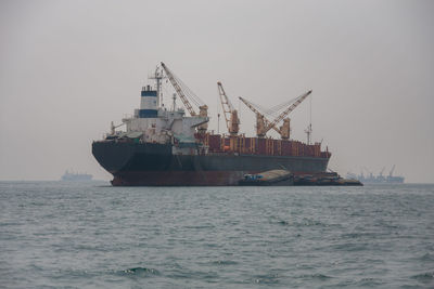 Ship sailing in sea against sky