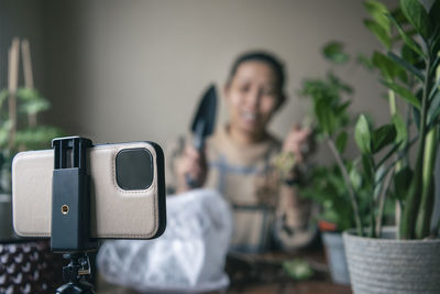 Woman vlogging about potted plants