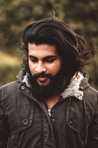 Close-up of bearded young man looking away outdoors