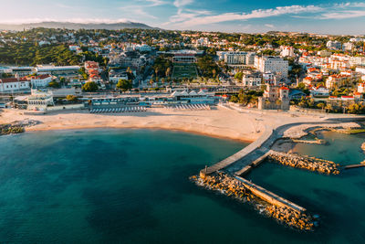 High angle view of townscape by sea against sky