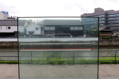 Buildings in city seen through glass window