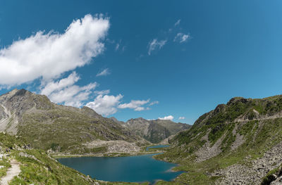 Aerial view of a beautiful lake surrounded by the dolomites mountain range in summertime