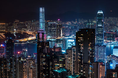 Illuminated cityscape against sky at night