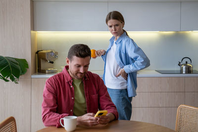 Side view of young man working at home
