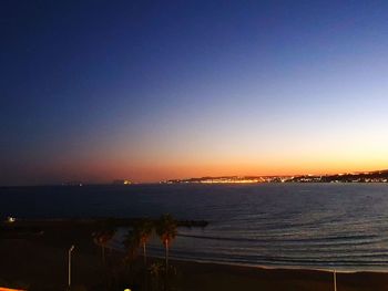 Scenic view of sea against clear sky at sunset