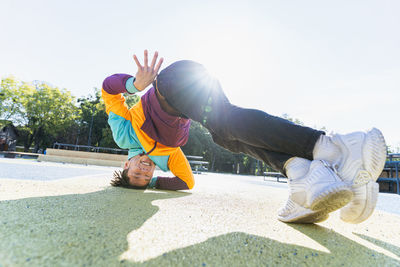 Low section of woman exercising on road
