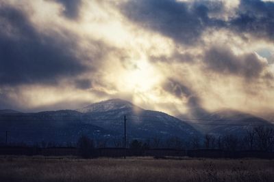 Scenic view of mountains against cloudy sky