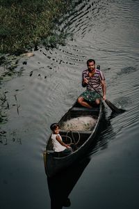 High angle portrait of man in boat on lake