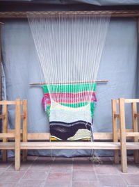 Empty chairs and table against wall