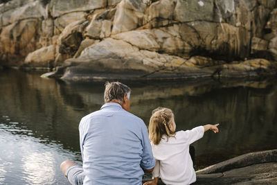 Father and daughter sitting at sea